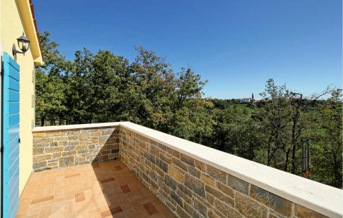 a balcony with a brick wall and trees at 6 Bedroom Cozy Home In Pazin in Brajkovići