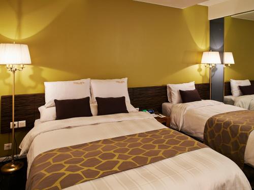 Кровать или кровати в номере Hotel Matthieu Yeosu