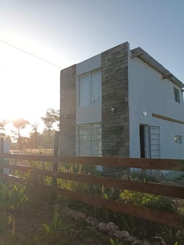 a house with a fence in front of it at El Campito in Necochea