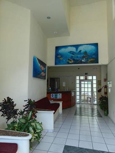 a living room with a couch and a kitchen at HOTEL ATLANTIDA in Playa del Carmen