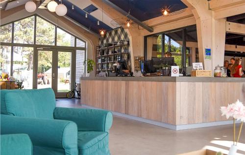 a store with two blue chairs and a counter at Awesome StaCaravan In Callantsoog in Callantsoog
