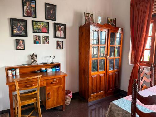 a room with a desk and a cabinet and a table at The Tenthola in Kandy