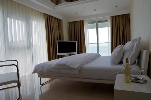 a bedroom with a large bed with a television on it at Venn Boutique Hotel in Samsun