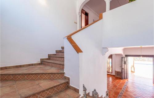 a staircase in a home with white walls and wooden floors at Pet Friendly Home In Malaga in Málaga