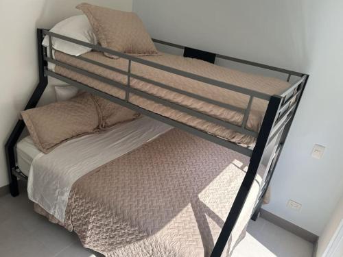 a black bunk bed with pillows on top of it at Punta Verde Beach Condo in Tarcoles