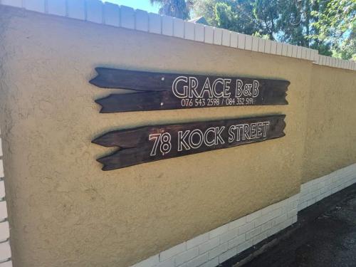 a sign on the side of a brick wall at Grace B&B in Potchefstroom