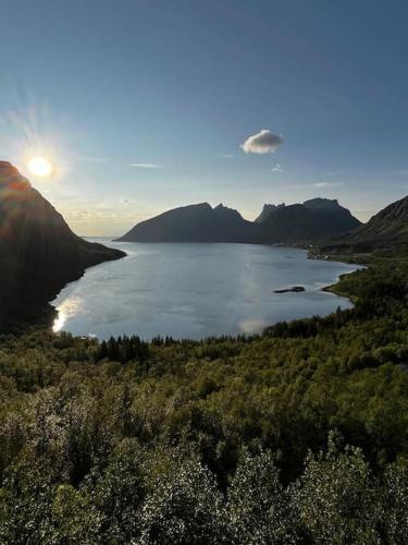 a view of a large body of water with mountains at Just a Simple House in Senjahopen