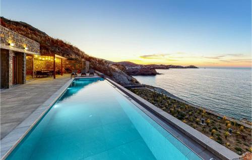a swimming pool with a view of the ocean at Stunning Home In Gazi, Heraklio in Lygaria