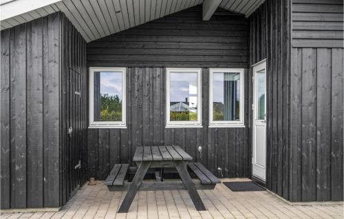a bench sitting in the corner of a room with windows at Holiday Home Chr Jacobsensvej in Årøsund