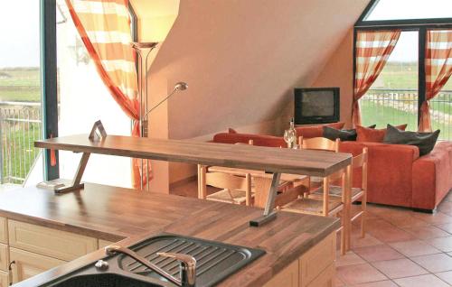 a living room with a table and a couch at Cozy Apartment In Börgerende-Rethwisch in Börgerende-Rethwisch