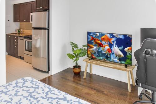 a painting on a table in a kitchen with a refrigerator at City View Towers - Steps to CN Tower - Pool & Hot tub - Free Parking in Toronto
