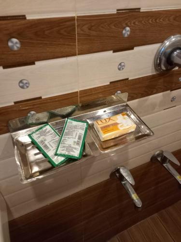 a tray with cakes on a counter in a bathroom at Stains holidayhome & party floor, Cherai beach in Pallipuram