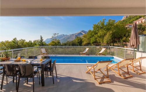 a patio with a table and chairs and a swimming pool at Gorgeous Home In Brela in Brela