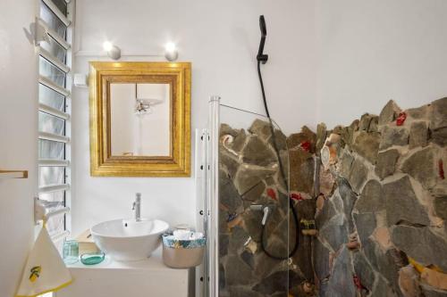 un baño con lavabo y espejo en Bungalow Les Beaux Arts, en Le Diamant