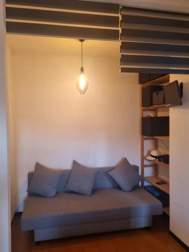 a bed with blue pillows in a room at Domus Flavio in Marina di Cerveteri