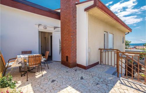 a balcony of a house with a table and chairs at Gorgeous Apartment In Crikvenica in Crikvenica