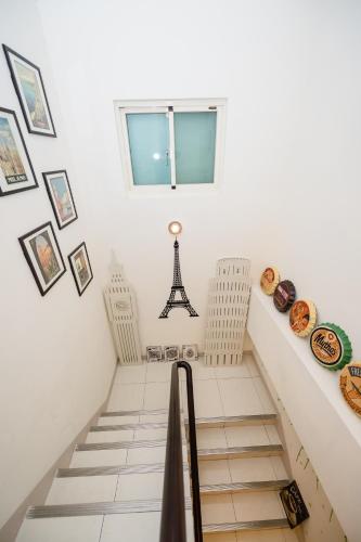a staircase with pictures of the eiffel tower at 巴黎Villa 主題派對K歌 BBQ 麻將包棟 in Luodong