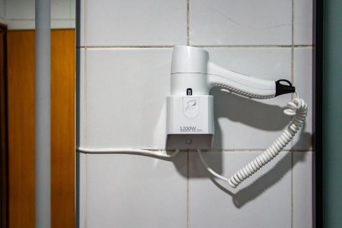 a hair dryer on a wall in a bathroom at Dalmatinska Cheyf Retreat in Sarajevo