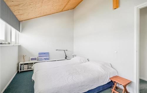 a bedroom with a white bed and a wooden ceiling at 3 Bedroom Amazing Home In Wieringerwerf in Wieringerwerf