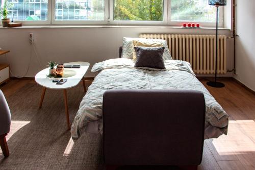 a bedroom with a bed and a table and a table at Dalmatinska Cheyf Retreat in Sarajevo