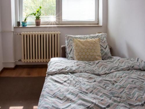 an unmade bed in a bedroom with a window at Dalmatinska Cheyf Retreat in Sarajevo