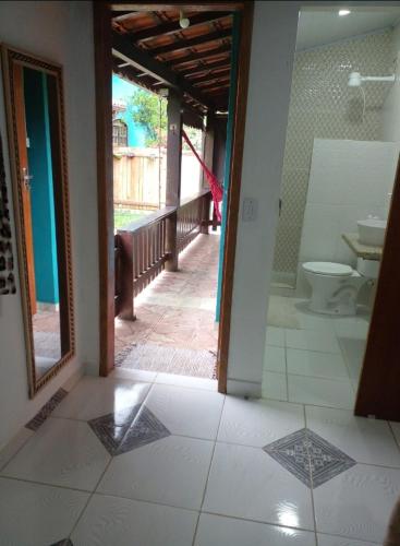 an open doorway to a bathroom with a toilet at Suítes portal do bosque in Visconde De Maua