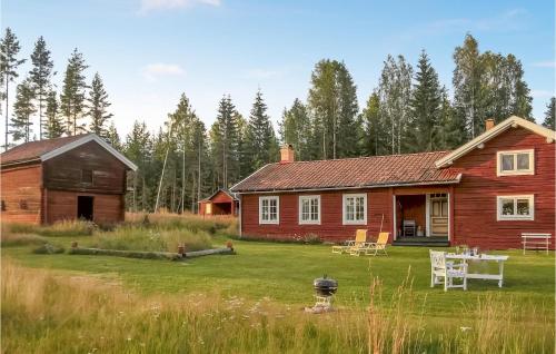a wooden house with a table and chairs in a yard at 5 Bedroom Pet Friendly Home In Vallsta in Vallsta