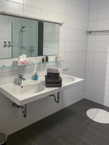a white bathroom with a sink and a mirror at Ferienwohnung Karlstadt in Karlstadt