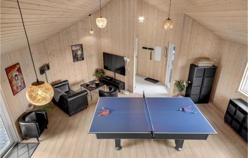 a living room with a ping pong table in a room at Lovely Home In Tisvildeleje With Sauna in Holløselund