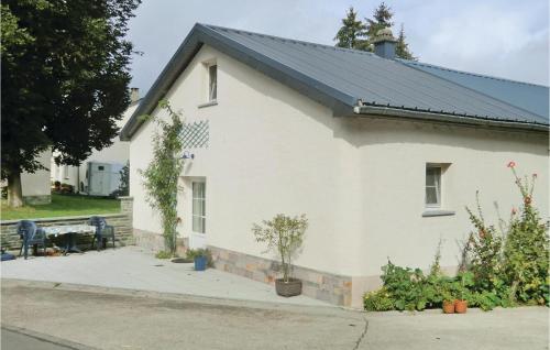 a white house with a black roof at Amazing Home In Hachiville With Wifi in Hachiville