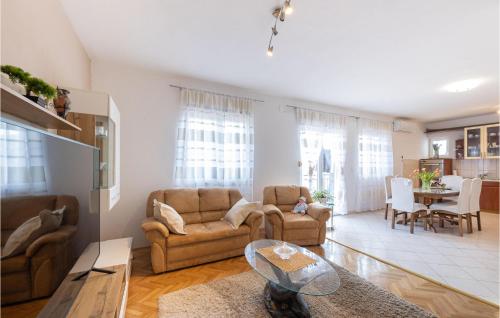 a living room with two couches and a table at Cozy Home In Neoric With Wifi in Neorić