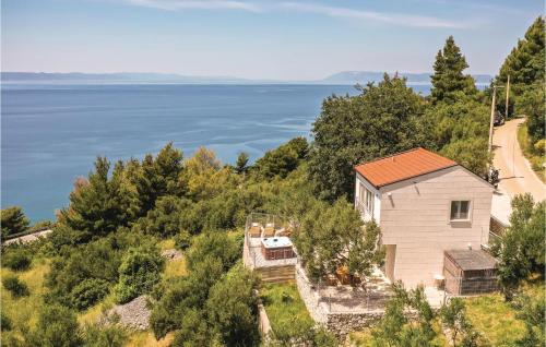 an image of a house with a view of the water at Two-Bedroom Holiday Home In Podgora in Podgora