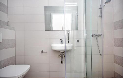 a bathroom with a sink and a glass shower at Two-Bedroom Holiday Home In Podgora in Podgora