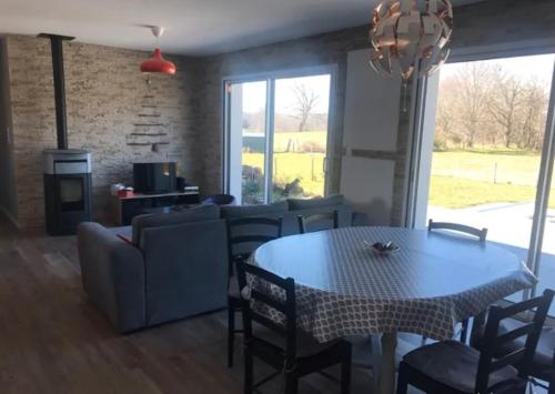 un salon avec une table et un canapé dans l'établissement maison rue de la plage, à Lanobre