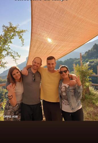 a group of four people posing for a picture at Casa Sangineto - Minori - Costa Amalfitana- A Paradise in the countryside in Minori