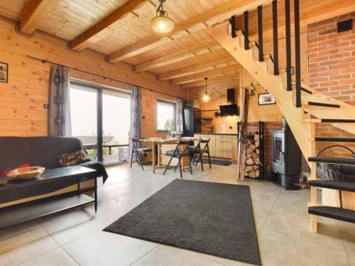 a living room with a couch and a staircase in a house at Sękata Chata in Szczyrk