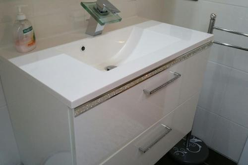 a white bathroom with a sink and a toilet at -Alirina- Ferienwohnung, 2 Schlafzimmern,Parkplatz in Oberkotzau