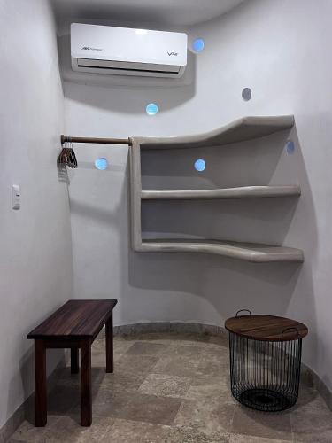 a room with a fan and a table and a bench at Villas Cononda in La Majahua