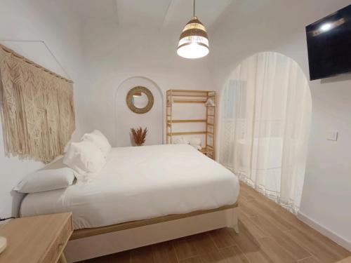 En eller flere senge i et værelse på Casa Medina