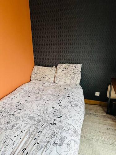 une chambre avec un lit avec une couette blanche dans l'établissement coup de coeur rooftop vertou proche Nantes, à Vertou