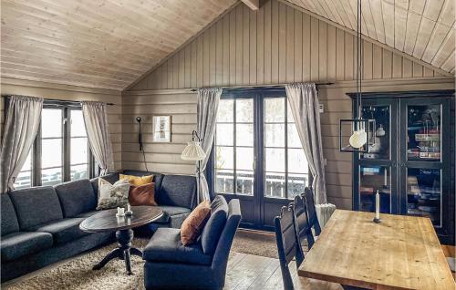 a living room with a couch and a table at Cozy Home In Bykle With Kitchen in Bykle