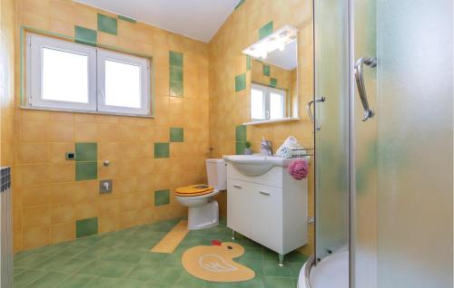 a bathroom with a toilet and a sink and a shower at Three-Bedroom Apartment In Rogotin in Rogotin