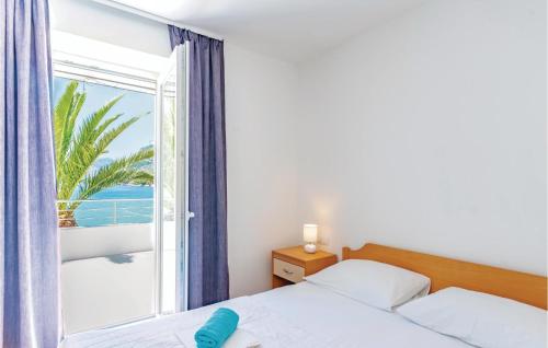 a bedroom with a bed and a large window at Holiday Home Zuljana 21 in Žuljana