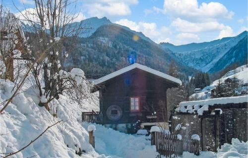 a small house in the snow with a fence at Ferienhaus In Maria Luggau in Maria Luggau