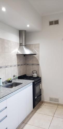 a kitchen with a stove and a sink at Espacio Millán in Concepción del Uruguay