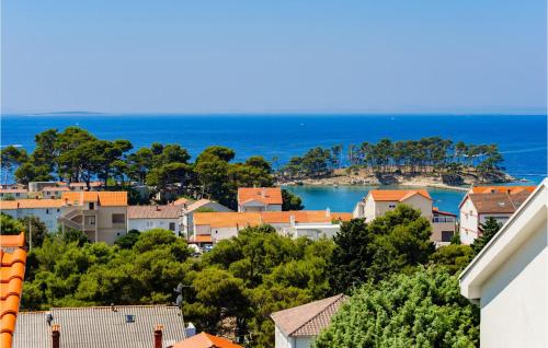 a view of a town with the ocean in the background at 2 Bedroom Nice Apartment In Banjol in Banjol