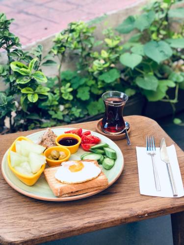 a plate of food with an egg and vegetables on a table at Hostel Le Banc in Istanbul