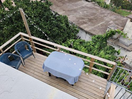 a blue bench sitting on top of a wooden deck at Casa Vintage Seixal Madeira in Seixal