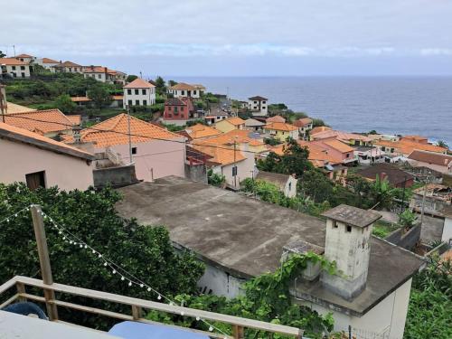 a view of a town with the ocean at Casa Vintage Seixal Madeira in Seixal