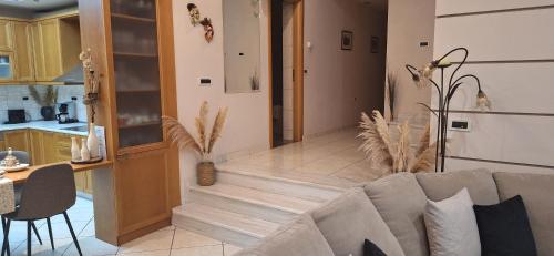 a living room with a couch and a kitchen at Modern Villa in Chania in Perivólia